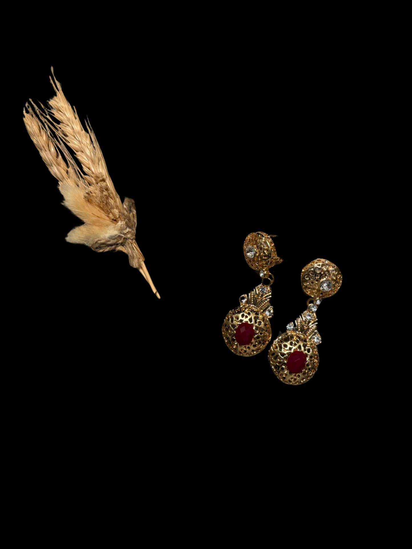 Gold earrings with red stone.